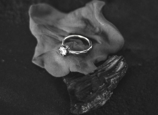 Verlobungsring mit Diamant in einer dunklen Bildgestaltung